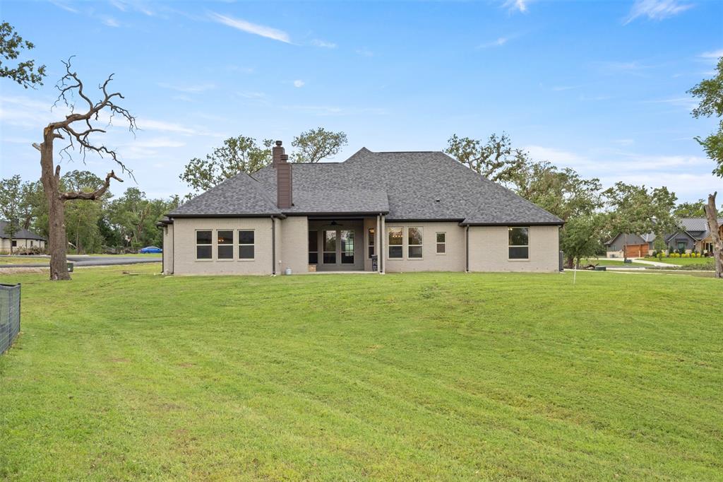 105 Clayton Crossing Springtown, TX 76082 - Photo 33 of 40 a view of a house next to a big yard