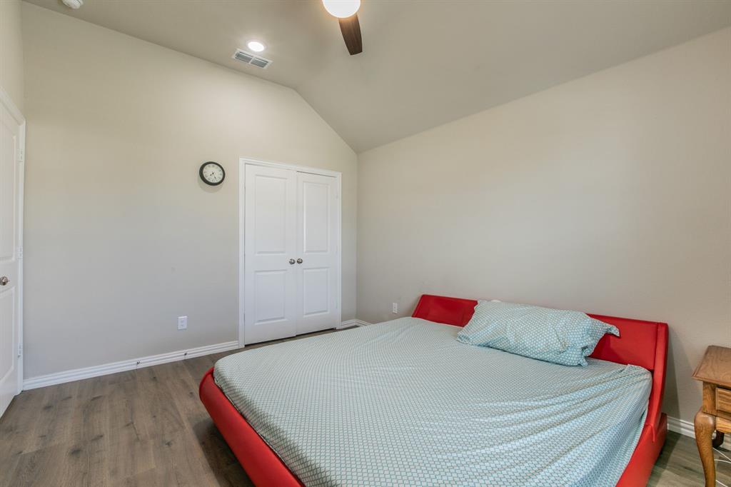 2521 Maidenhair Road Frisco, TX 75033 - Photo 21 of 39 Bedroom featuring vaulted ceilings, wood-finish flooring, recessed lighting, ceiling fan, and double-door closet
