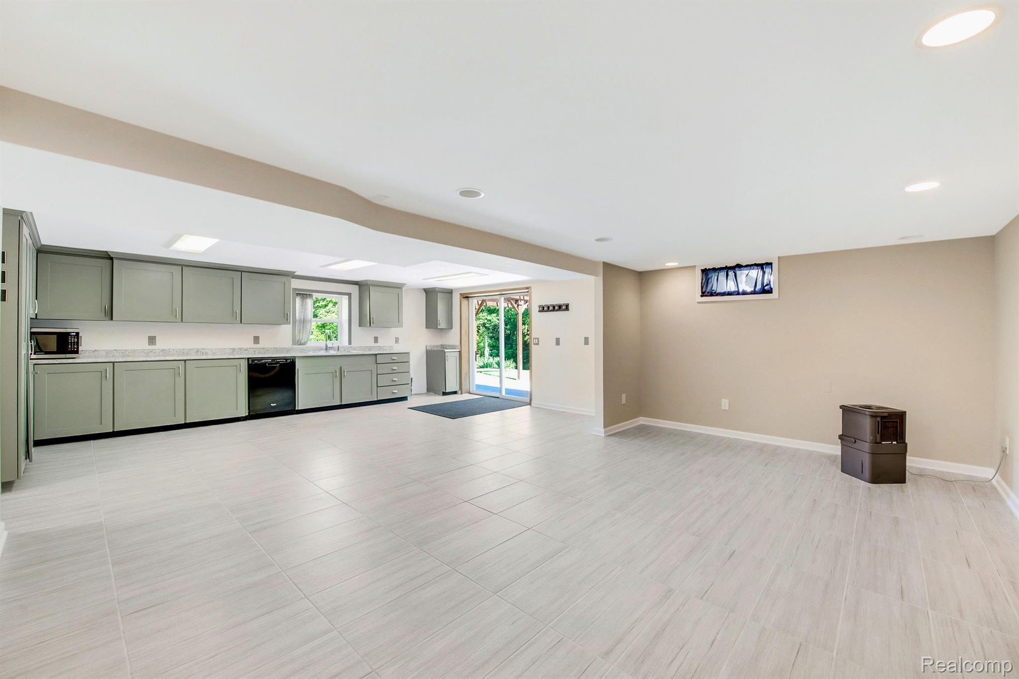 5102 South Lapeer Road Metamora, MI 48455 - Photo 30 of 42 Finished large basement area FR/Kitchen area.