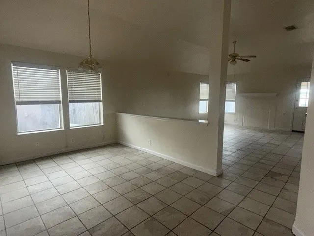 an empty room with windows and painted walls