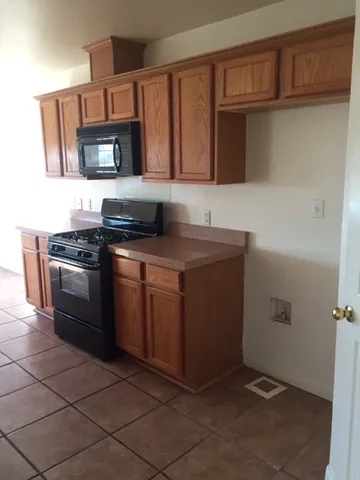 a kitchen with stainless steel appliances a sink stove and cabinets