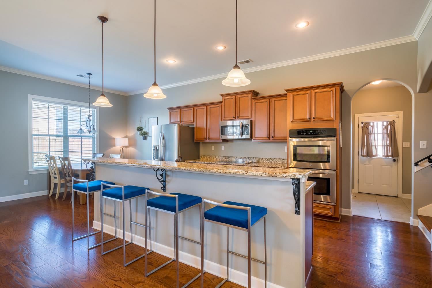 254 Estanaula Road Collierville, TN 38017 - Photo 7 of 25 a kitchen with stainless steel appliances granite countertop wooden floors stove and cabinets