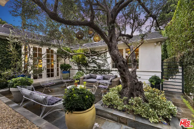 a view of a house with a yard and sitting area