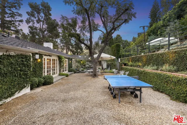 a swimming pool with outdoor seating and yard