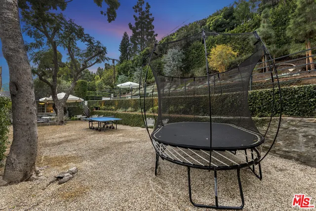 a backyard of a house with table and chairs