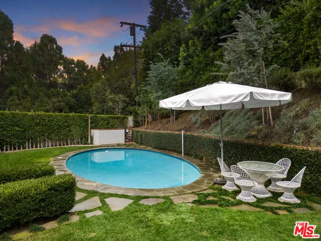 a backyard of a house with table and chairs