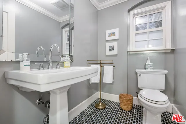 a bathroom with a sink toilet and a mirror