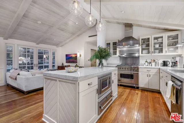 a kitchen with stainless steel appliances granite countertop a stove and cabinets