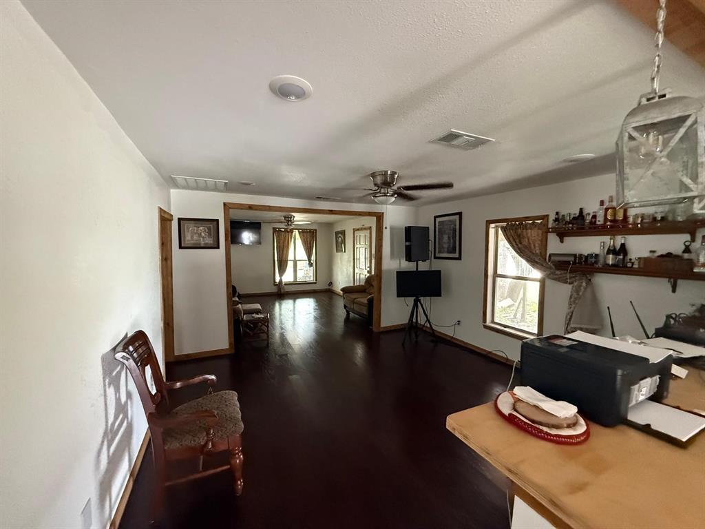 900 North Tiffin Road Ranger, TX 76470 - Photo 14 of 33 Office with dark wood-style floors, a ceiling fan, and a textured ceiling
