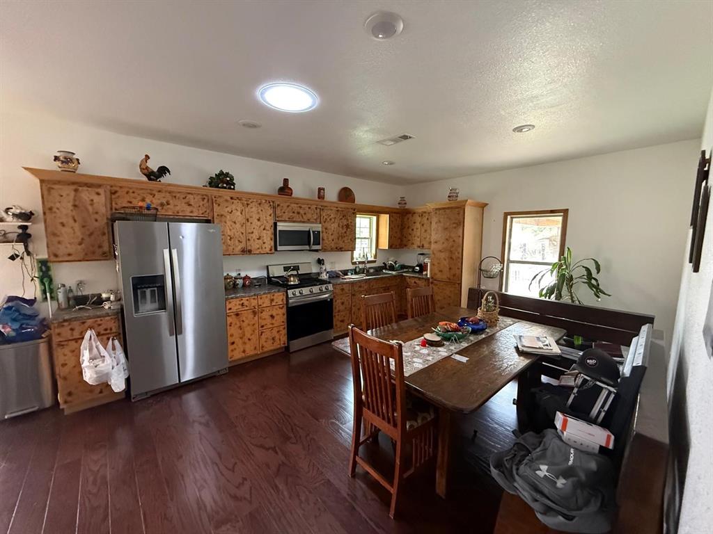 900 North Tiffin Road Ranger, TX 76470 - Photo 16 of 33 a kitchen with granite countertop a refrigerator stove and sink