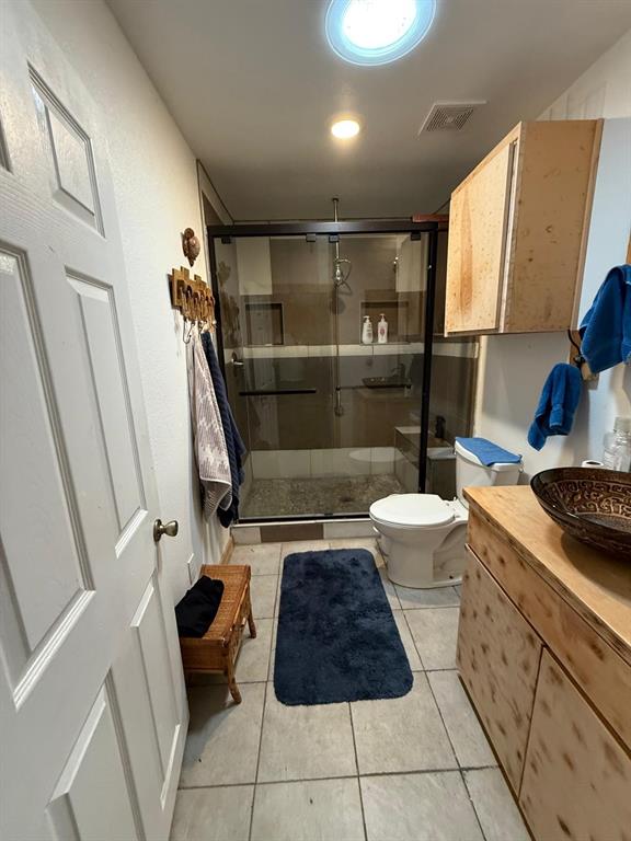 900 North Tiffin Road Ranger, TX 76470 - Photo 17 of 33 a bathroom with a granite countertop sink a toilet and a shower