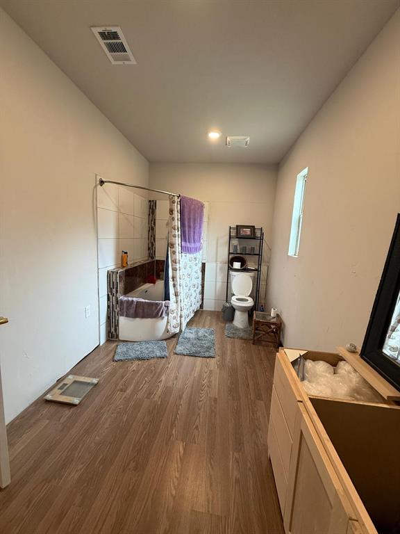 900 North Tiffin Road Ranger, TX 76470 - Photo 23 of 33 Bedroom featuring dark wood-style flooring