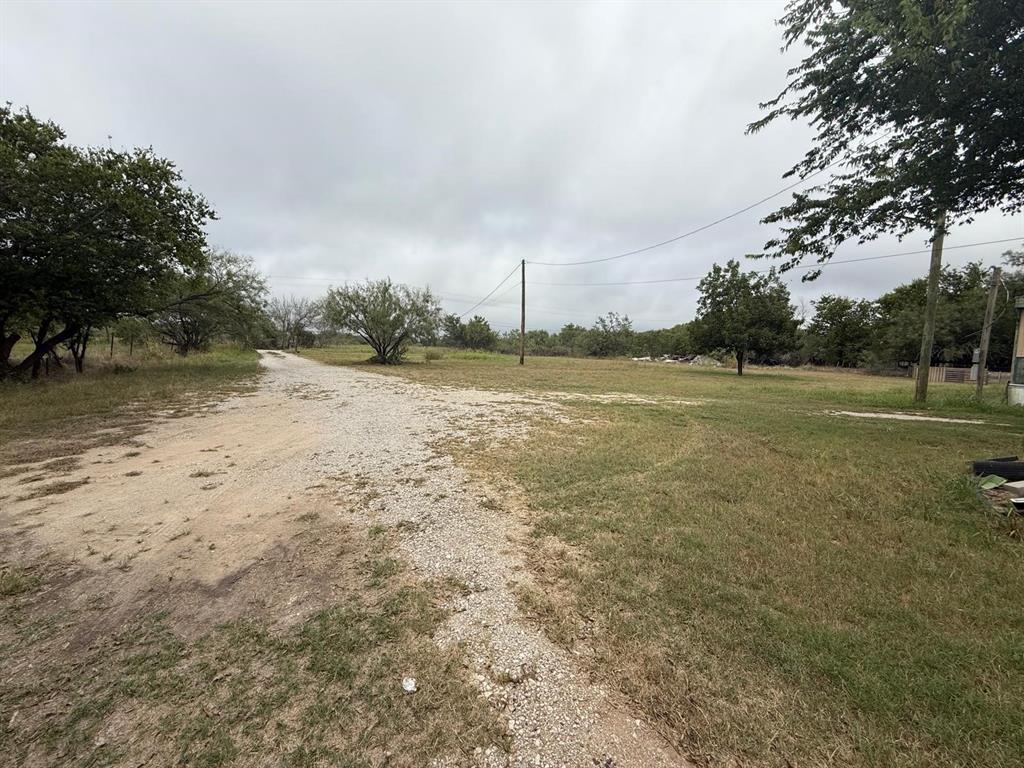 900 North Tiffin Road Ranger, TX 76470 - Photo 31 of 33 a view of a field with trees in the background
