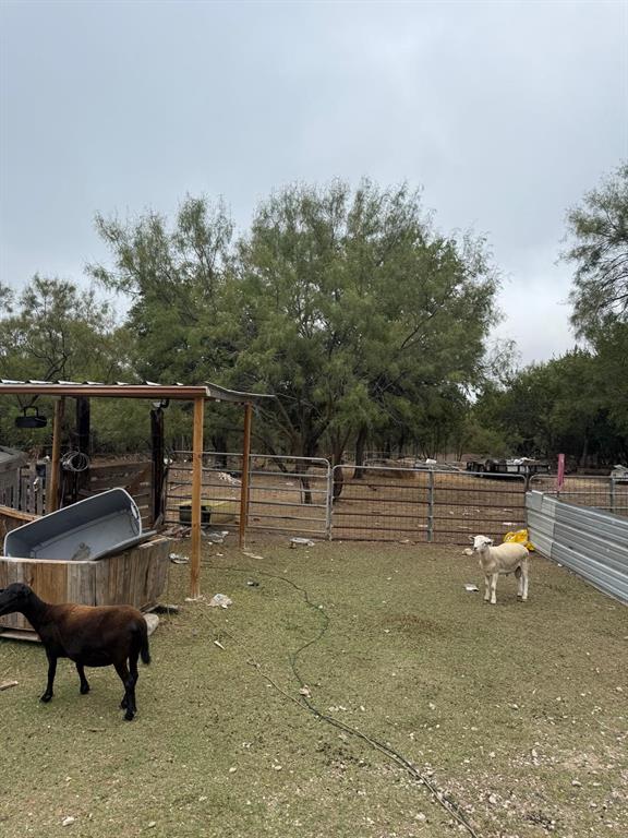 900 North Tiffin Road Ranger, TX 76470 - Photo 9 of 33 a view of a backyard with table and chairs