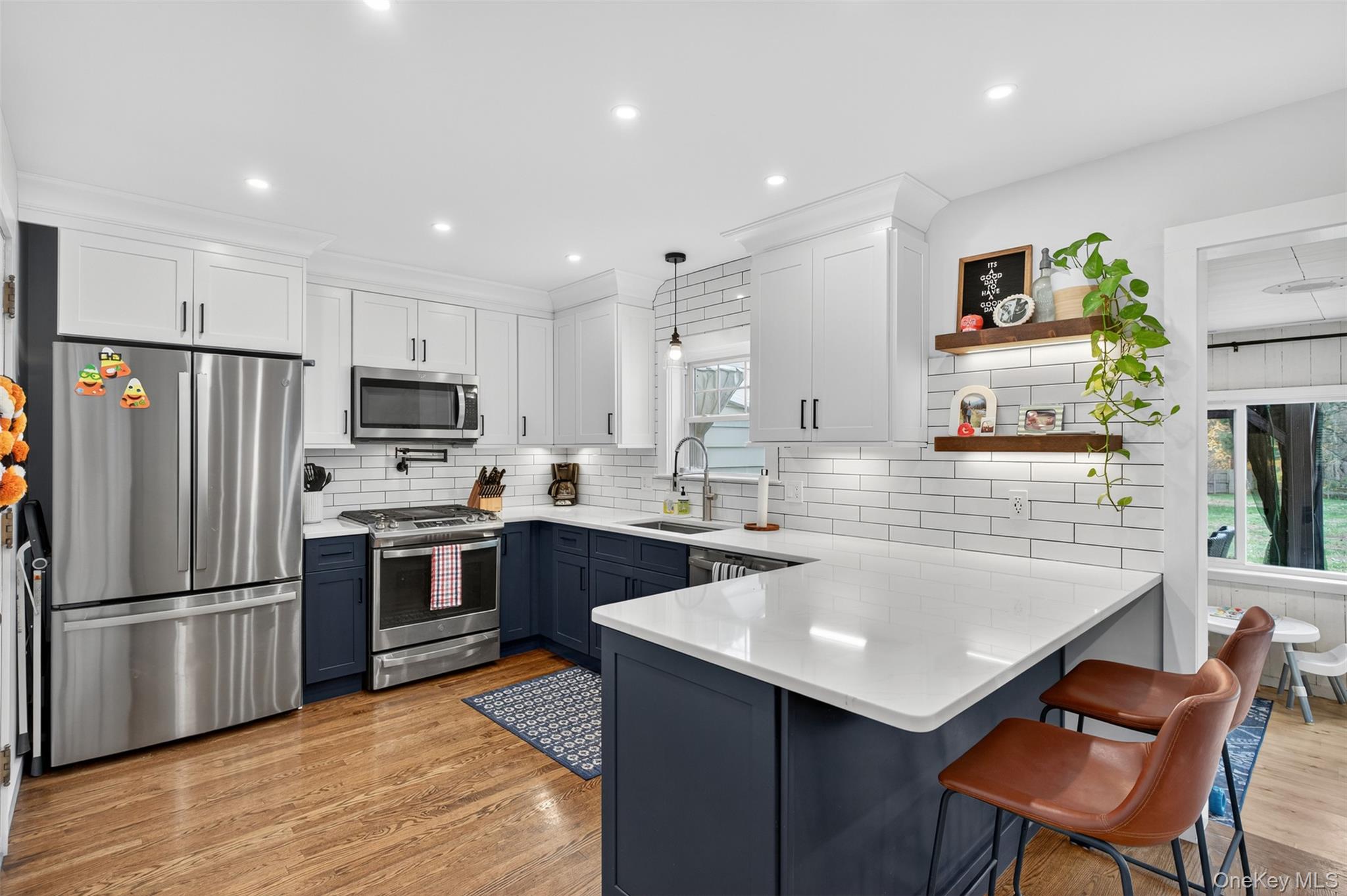 51 Ward Place Fishkill, NY 12524 - Photo 8 of 25 a kitchen with a refrigerator a stove a sink dishwasher with a dining table and chairs