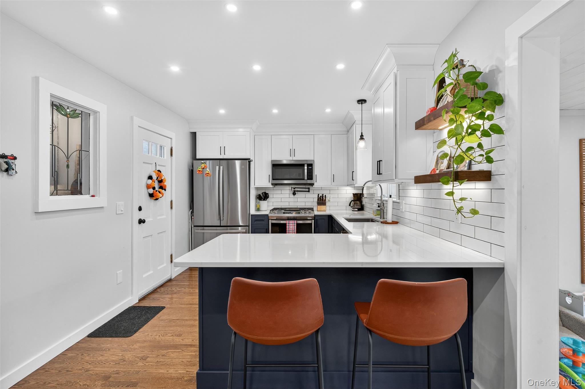 51 Ward Place Fishkill, NY 12524 - Photo 10 of 25 a kitchen with stainless steel appliances granite countertop a table chairs in it and wooden floors