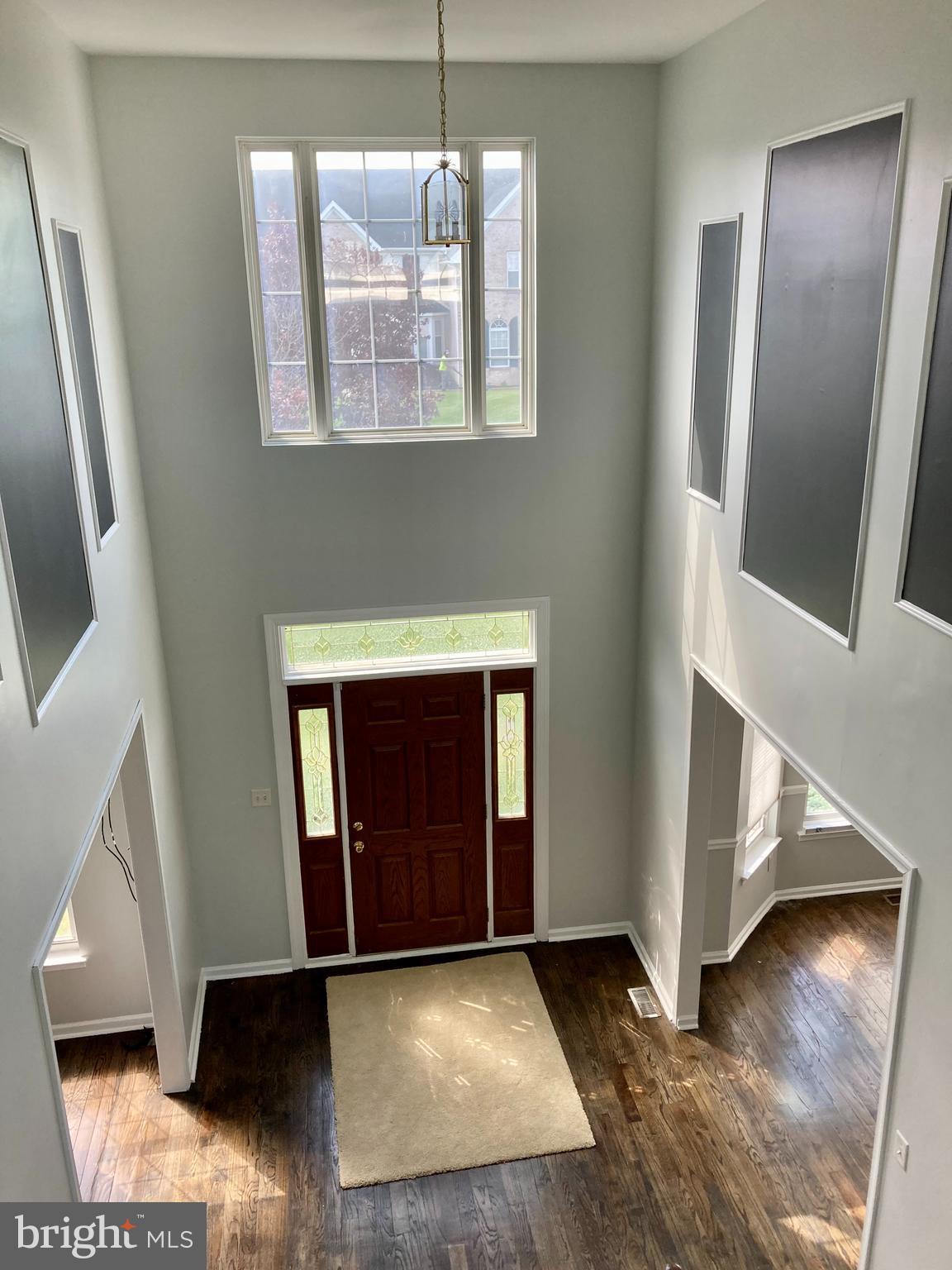 227 Mariners Way Bear, DE 19701 - Photo 2 of 19 a view of an empty room with wooden floor and a window