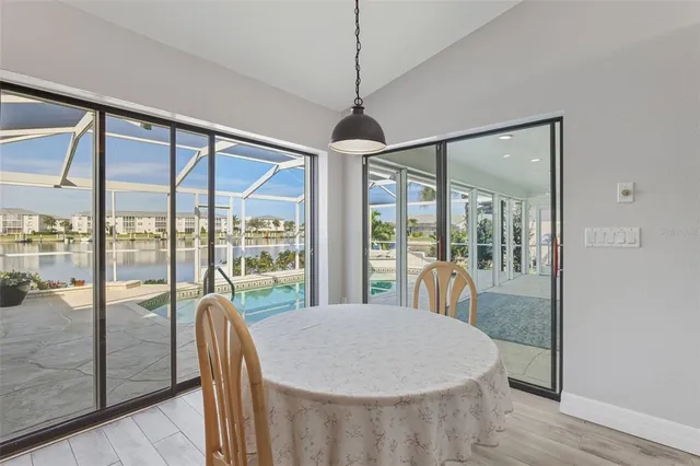 a dining room with glass top table and chairs
