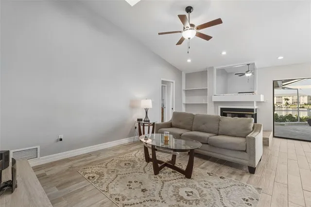 a living room with furniture and kitchen view