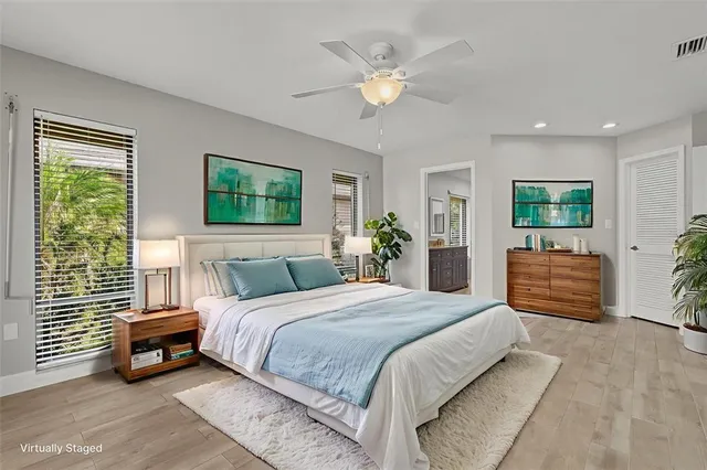 a bedroom with a large bed and a chandelier