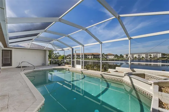 a view of a house with swimming pool and a yard