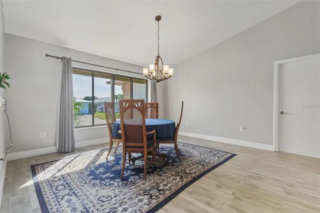 a dining room with furniture a rug and a chandelier