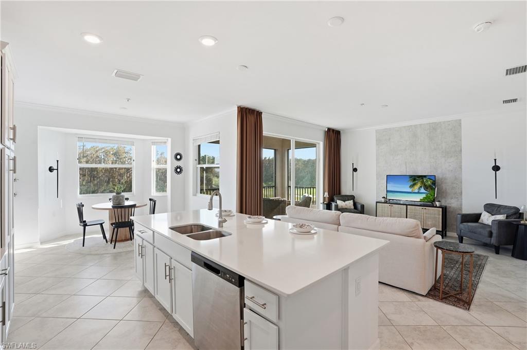 6046 National Boulevard, Unit 446 Immokalee, FL 34142 - Photo 47 of 50 a large living room with stainless steel appliances kitchen island granite countertop furniture and a couch