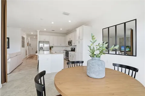a kitchen with sink refrigerator and microwave