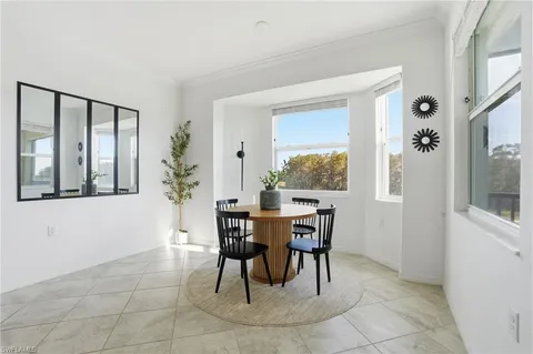 a view of a dining room with furniture and window