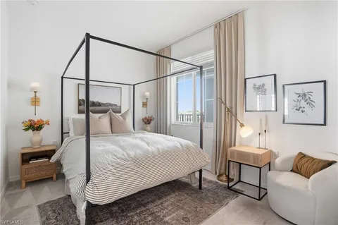 a bedroom with a bed and a lamp