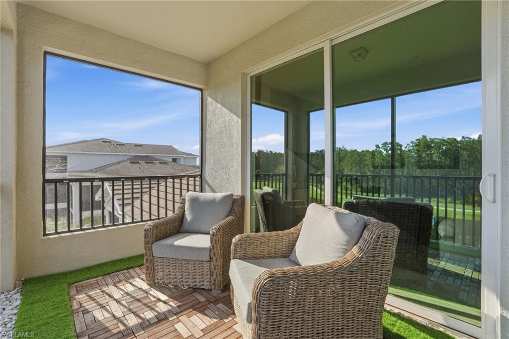 6046 National Boulevard, Unit 446 Immokalee, FL 34142 - Photo 20 of 50 a balcony with furniture and a garden