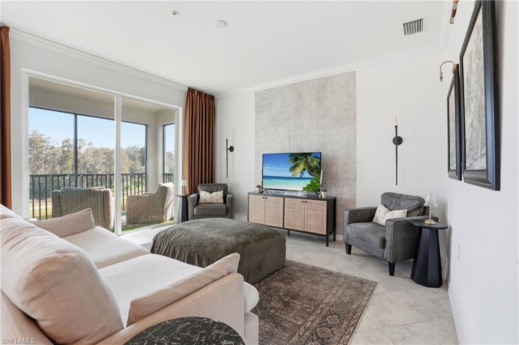 6046 National Boulevard, Unit 446 Immokalee, FL 34142 - Photo 6 of 50 a living room with furniture and a flat screen tv