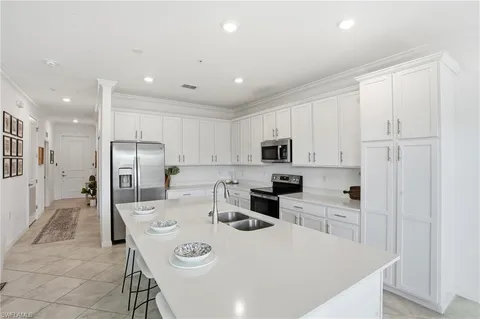 a kitchen with stainless steel appliances a refrigerator stove microwave and cabinets