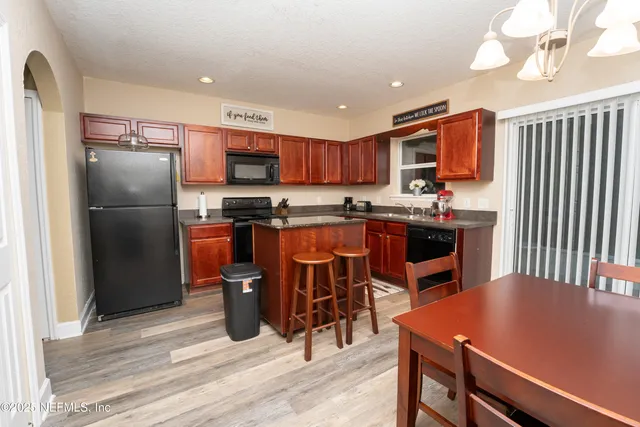 a kitchen with a table and chairs in it