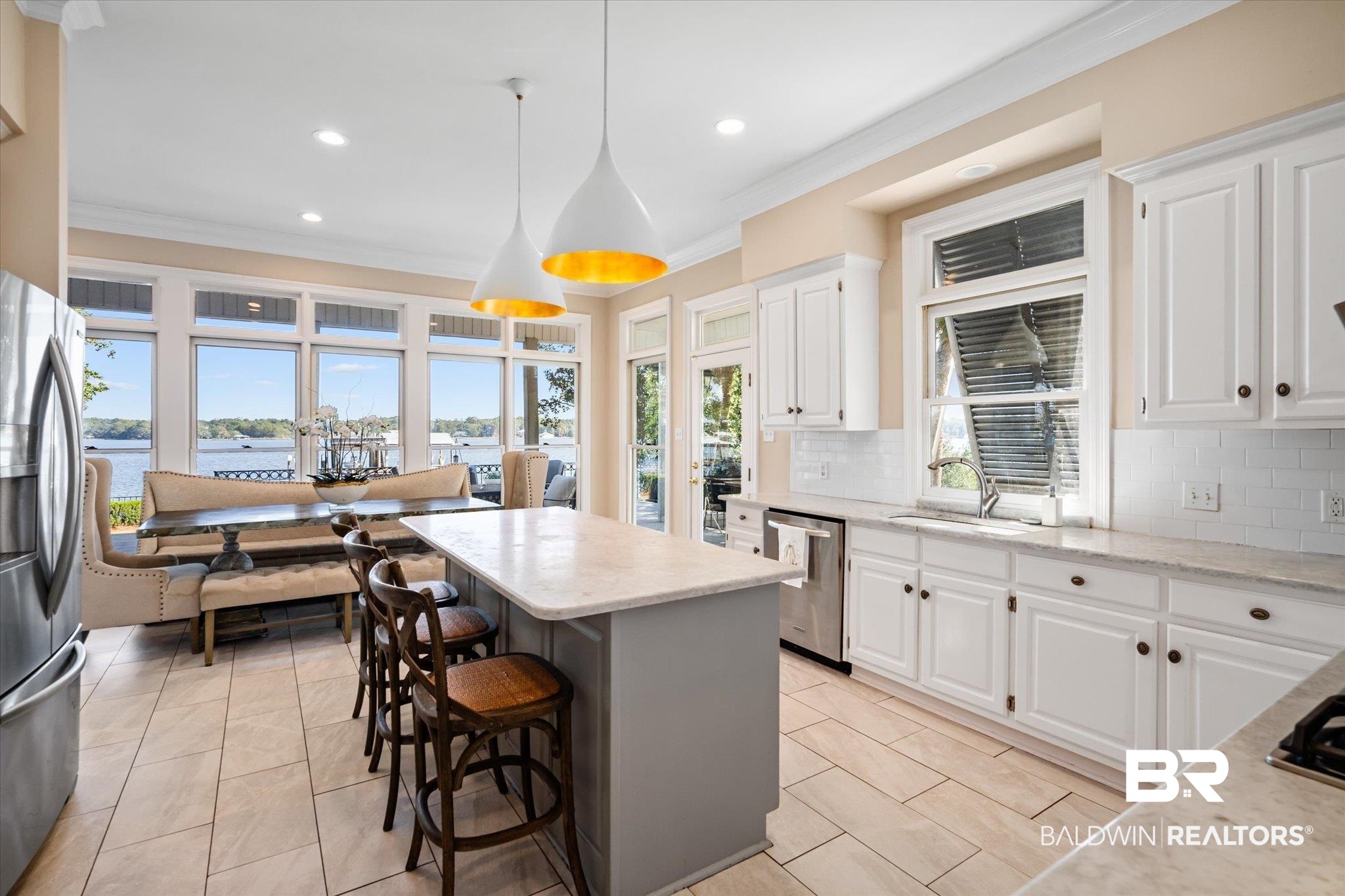 4930 River Trace Theodore, AL 36582 - Photo 13 of 57 Kitchen featuring white cabinetry, sink, a water view, and pendant lighting