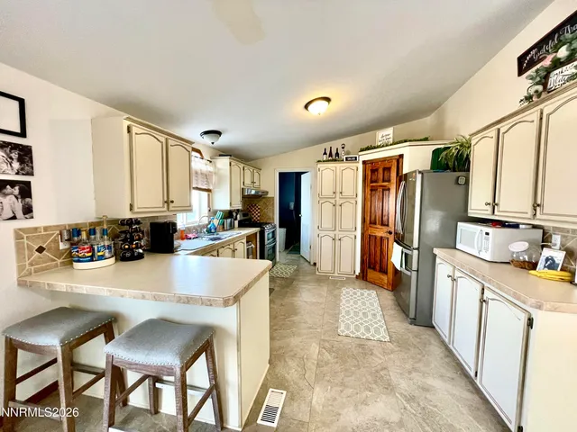 a view of a dining room with furniture and a table