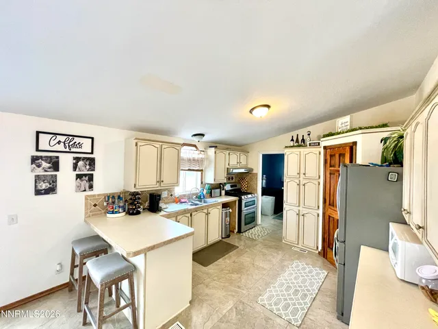 a work room with furniture and flat screen tv
