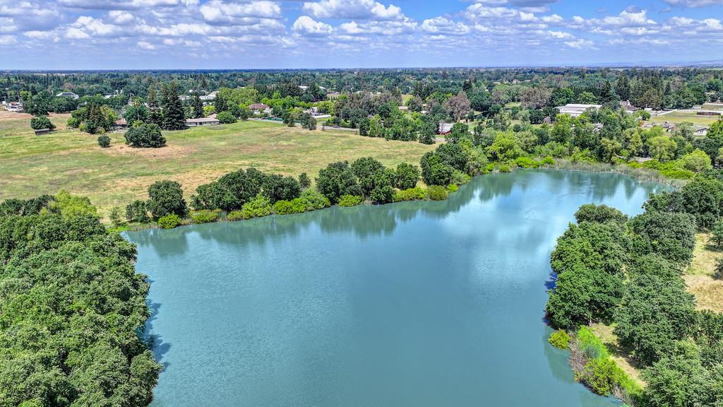 10500 Wilton Road Elk Grove, CA 95624 - Photo 23 of 31 a view of a lake with a building in the background