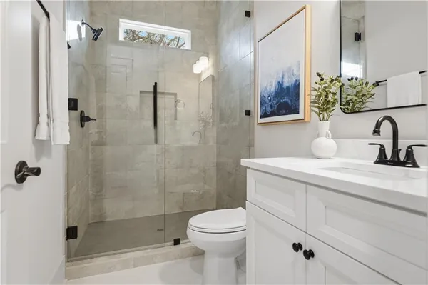 a bathroom with a sink a toilet and shower