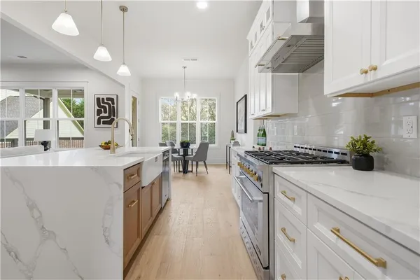 a kitchen with sink stove and cabinets