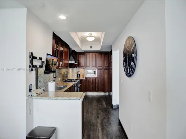 a view of a room with wooden floor
