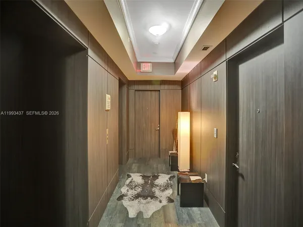 a view of a hallway view with wooden floor and staircase