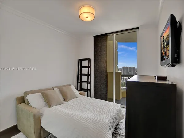 a bedroom with a bed and a flat screen tv