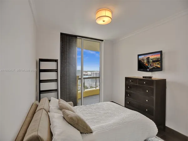 a bedroom with a bed and a night stand