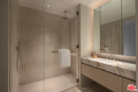 a bathroom with a double vanity sink and mirror