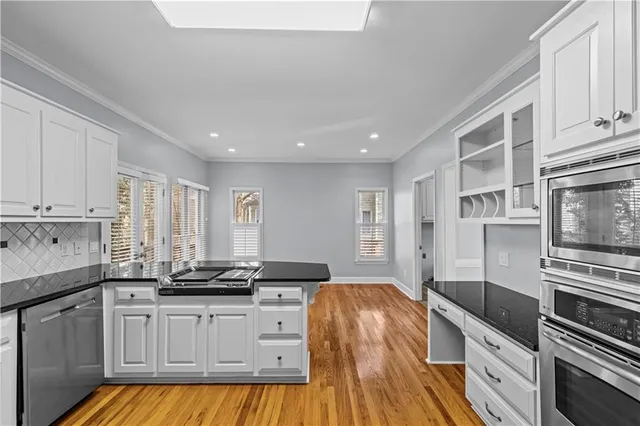 a kitchen with stainless steel appliances granite countertop a stove and a sink