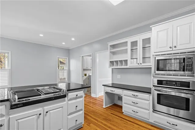 a kitchen with stainless steel appliances granite countertop a stove and a microwave