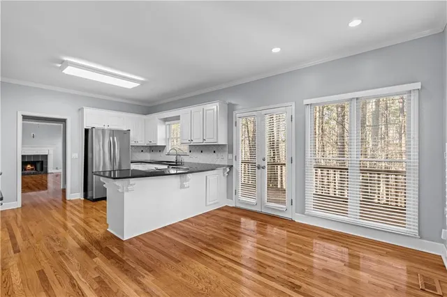 a kitchen with stainless steel appliances granite countertop a refrigerator and a sink