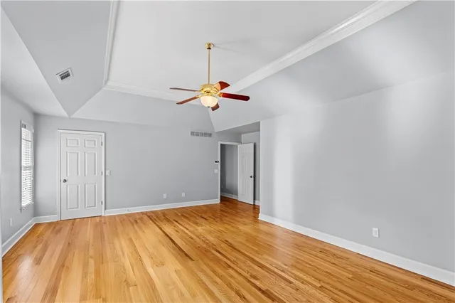 a view of empty room with wooden floor