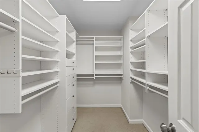 a view of walk in closet with empty racks
